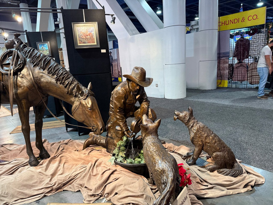 Bronze sculpture of a cowboy and his faithful companions at the Christmas 2025 event