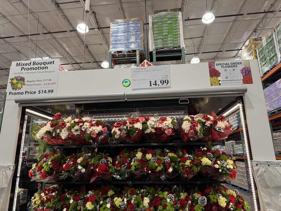 Colorful bouquets of holiday flowers, wrapped in clear plastic and displayed in the floral department.