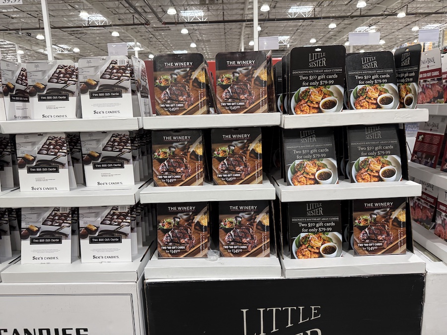 A display board featuring neatly arranged gift card packs for popular local and national brands, ready for holiday gifting.