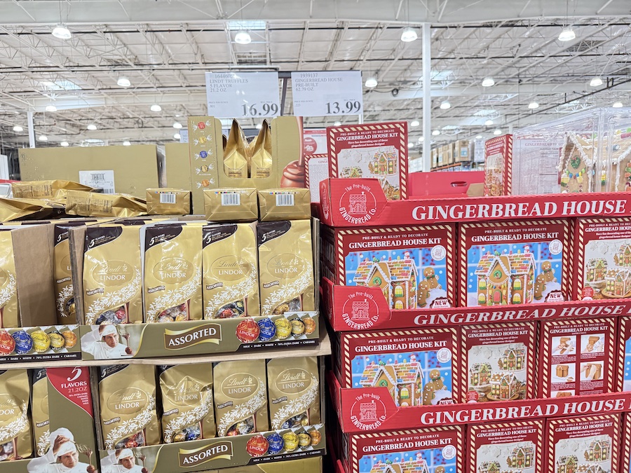 A gingerbread house inside a protective display box, ready for decorating.