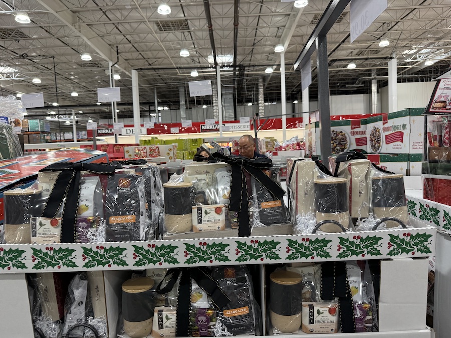 A holiday tray filled with assorted coffees, teas, and sweet treats, wrapped for gifting.
