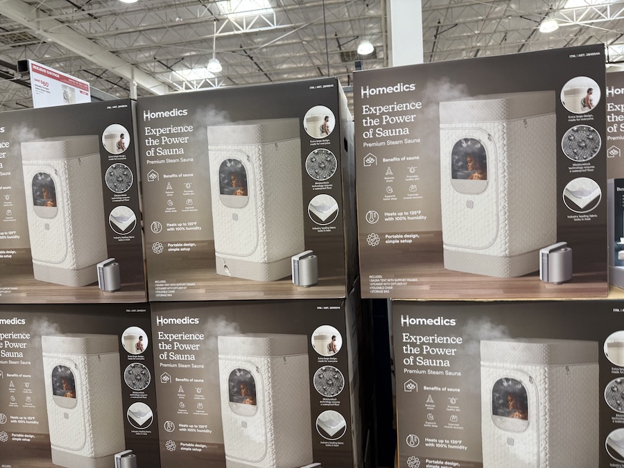 A boxed Homedics steam sauna unit sits on a warehouse pallet