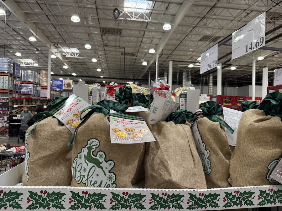 A tall themed bag filled with a variety of gourmet popcorn flavors.