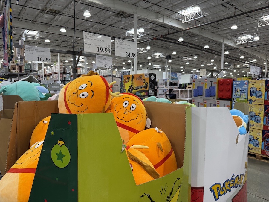 A large, plush 20-inch Grinch Squishmallow with his mischievous smile.