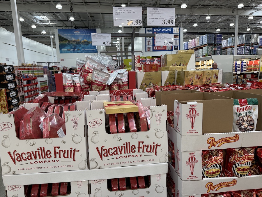 A clear-lidded fruit and nut tray arranged in festive holiday patterns.