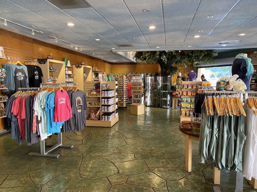 Clothing racks with LA Zoo T-shirts, hats, sweatshirts, and accessories.