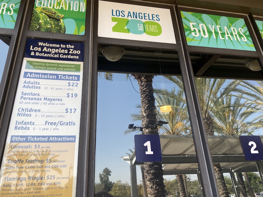 Banner listing LA Zoo ticket pricing, including adult, child, and senior admission rates.