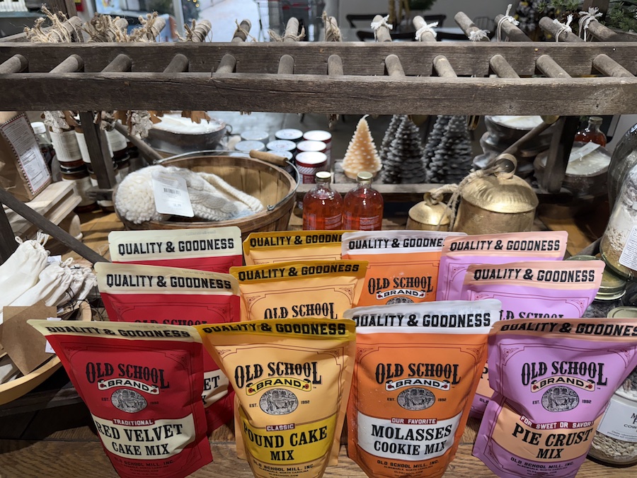 Shelves stocked with Old School Brand cookie and cake mixes, including molasses cookies, red velvet cake, pound cake, and pie crust mix.