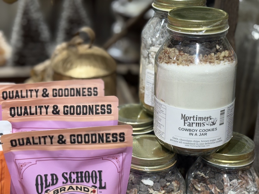 A rustic-style jar filled with layered ingredients for Cowboy Cookies, labeled for Mortimer Farms.