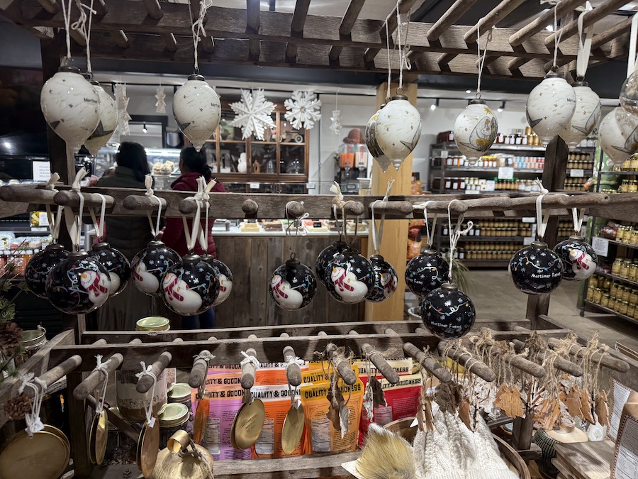 A display of various Christmas tree decorations, including festive ornaments and themed holiday balls.