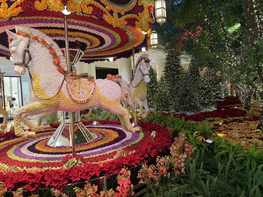 A close-up of the floral carousel’s intricate flower patterns with subtle Christmas ornaments woven into the design.