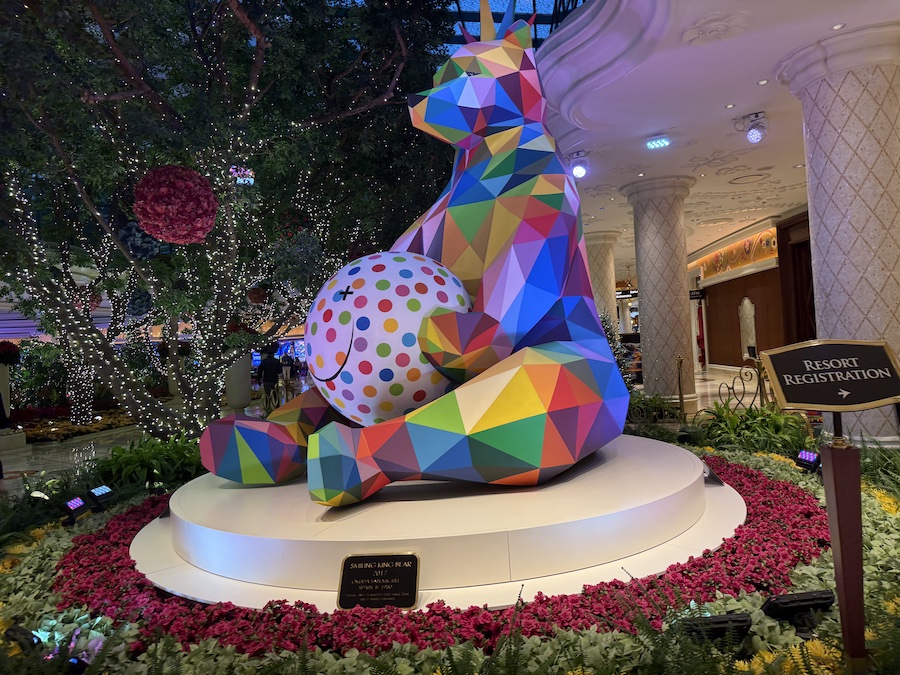 A close-up of the sculpture with sparkling ornaments and decorative lights at its base.