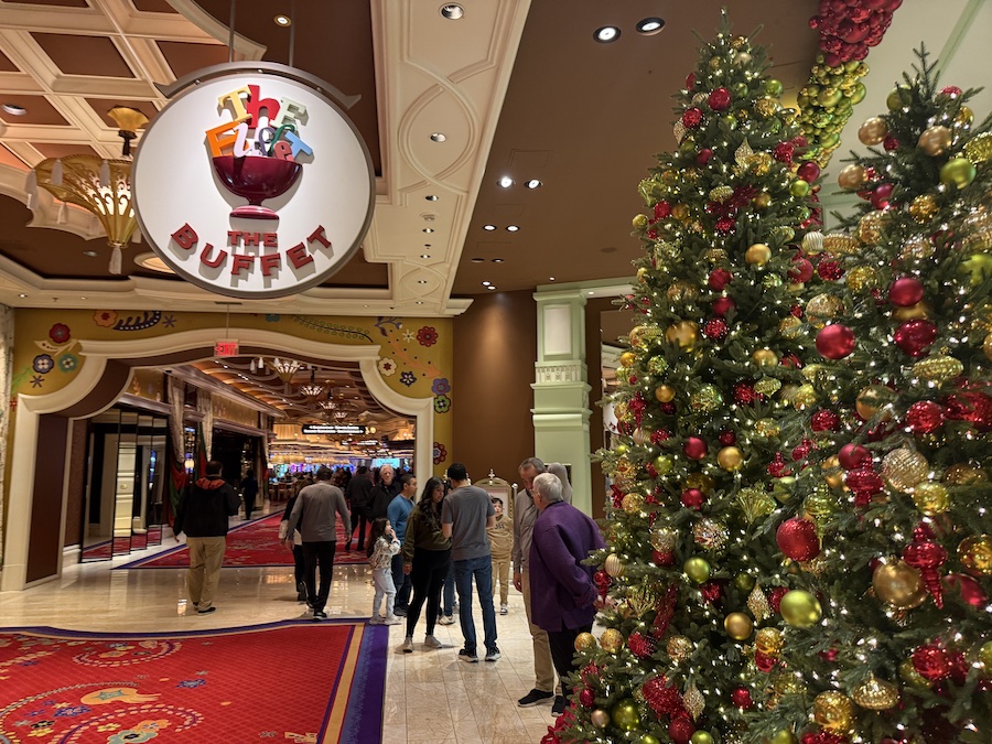 The entrance to The Buffet adorned with Christmas trees, garlands, and twinkling lights.