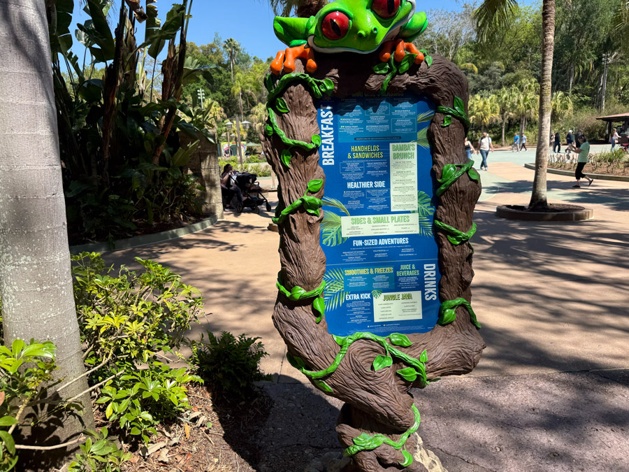 Rainforest Cafe outdoor menu sign with frog decoration at Disney’s Animal Kingdom Orlando.