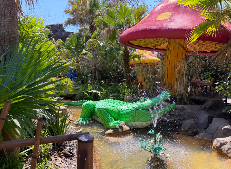 Rainforest Cafe crocodile fountain with tropical decor at Disney’s Animal Kingdom Orlando.