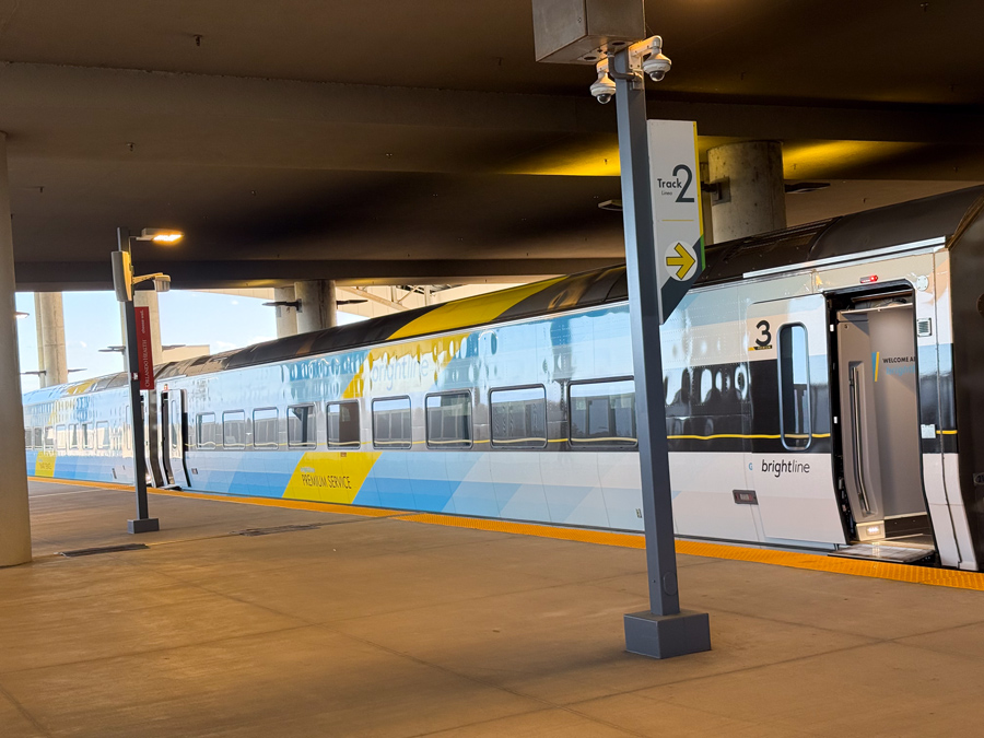 Boarding a train at the Brightline station platform.
