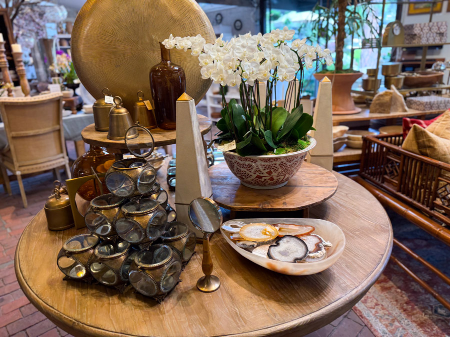 Decor on a round table - brass, glass, stone, Roger's Gardens