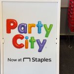 Party City now at Staples store entrance sign
