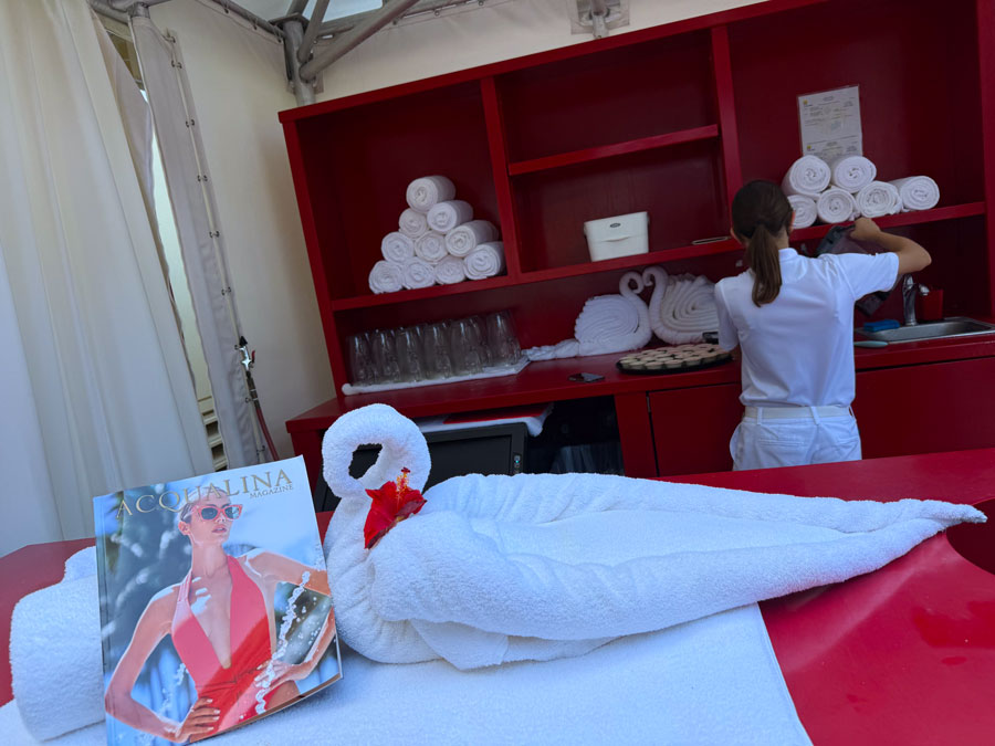 Luxury beach cabana setup with towel swan and refreshments at Acqualina Resort.