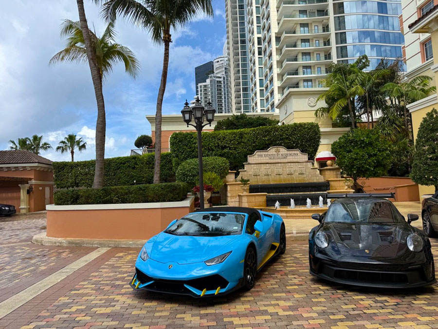 Luxury sports cars parked outside Acqualina Resort & Residences in Sunny Isles Beach.