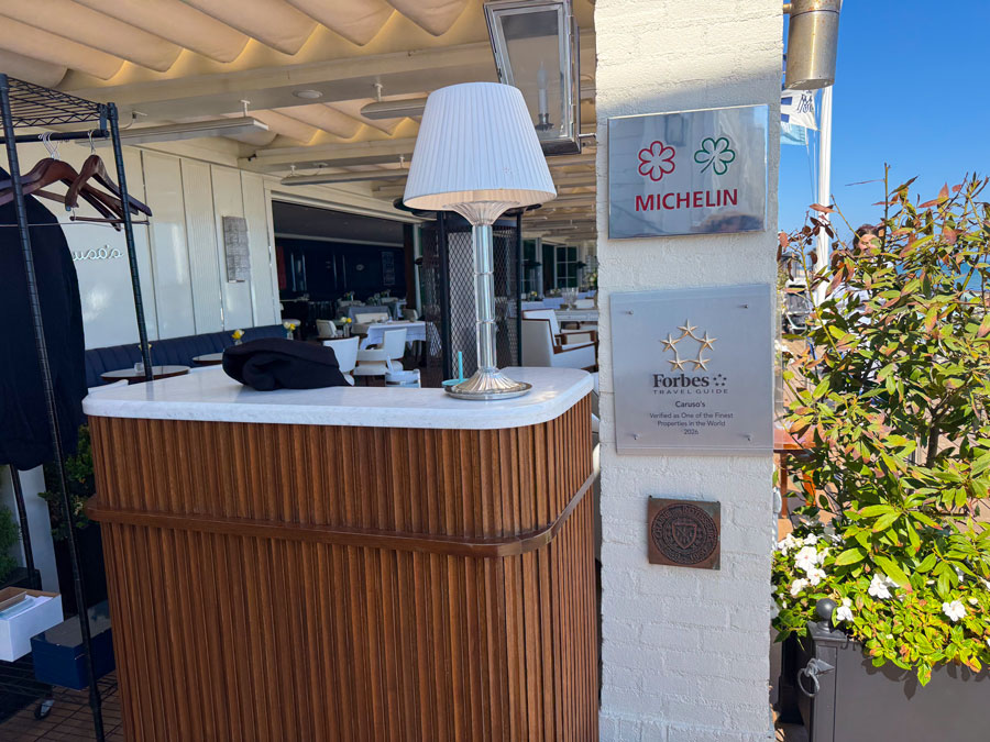 Caruso’s restaurant entrance with Michelin and Forbes Travel Guide plaques at Rosewood Miramar Beach
