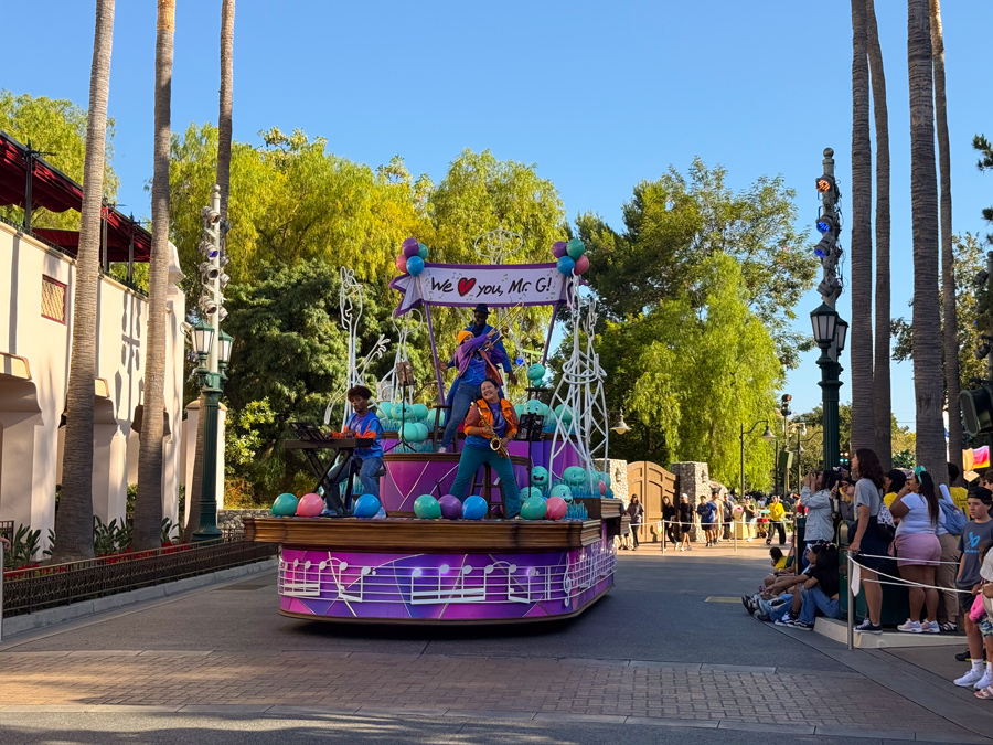 Musicians performing on a colorful Pixar Pals Celebration parade float
