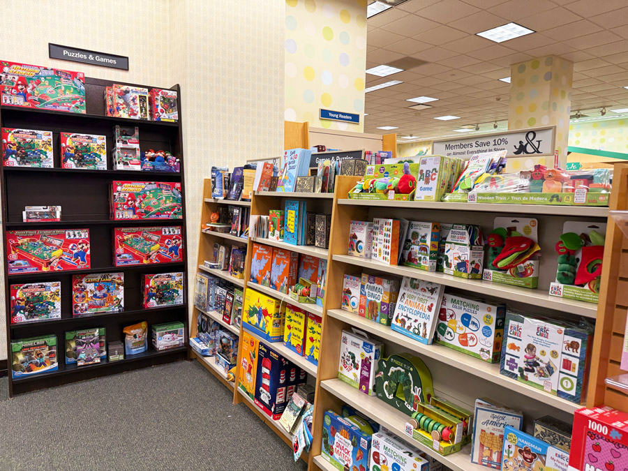 Children’s puzzles and games beside a Barnes & Noble member discount sign