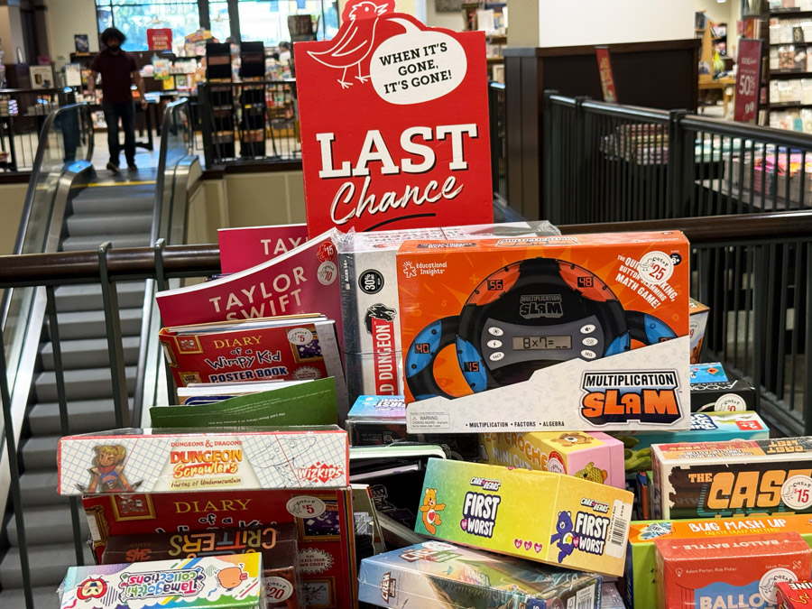 Barnes & Noble Last Chance sale display with discounted books, games, and toys