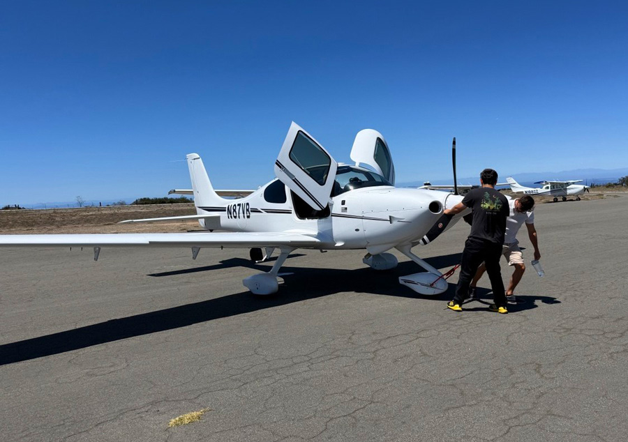 Front view of Cirrus SR20 N87VB with its doors open at Catalina Airport