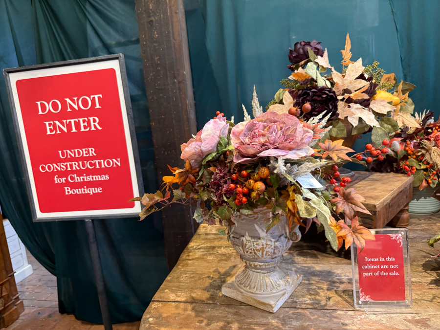 Christmas Boutique construction area with fall floral arrangements