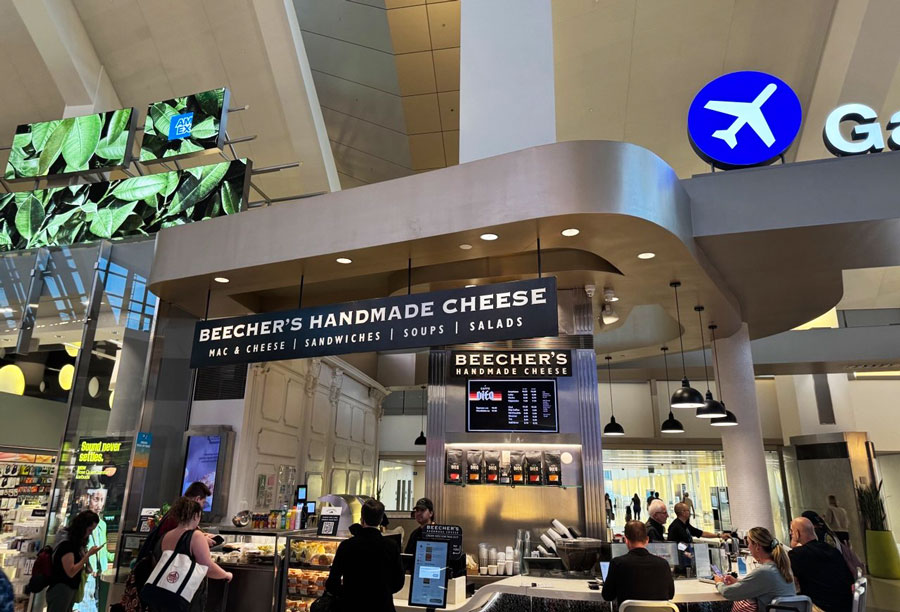 Beecher’s Handmade Cheese counter at LAX, with signs for mac and cheese, sandwiches, soups and salads.