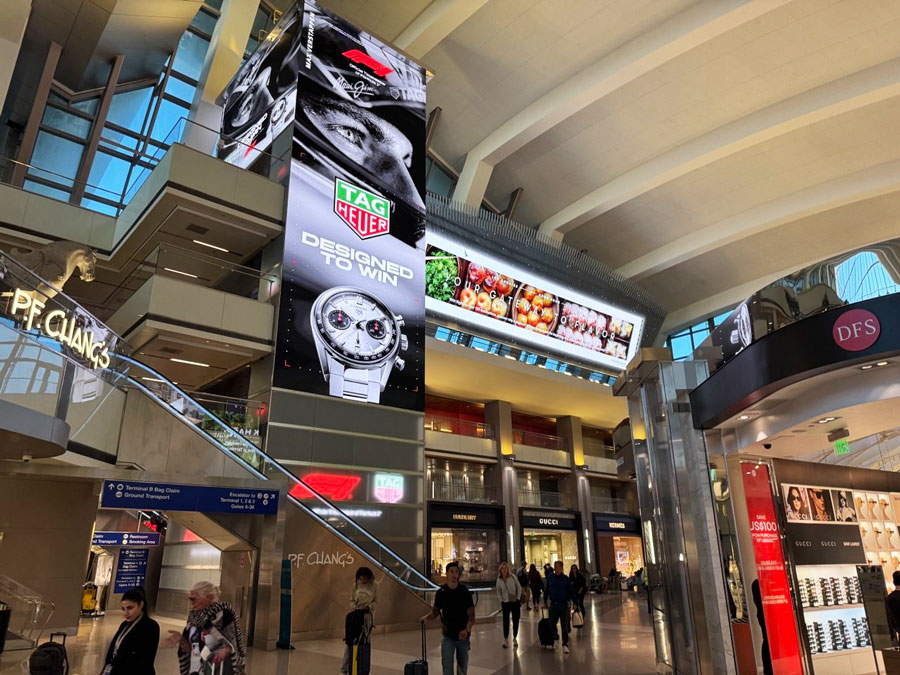 LAX Terminal B concourse with P.F. Chang’s, DFS, Gucci and Hermès storefronts.